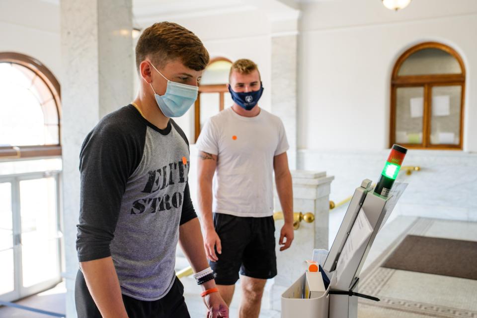 Siena Heights University students are seen at a self-screening station during the start of the 2020-21 school year.