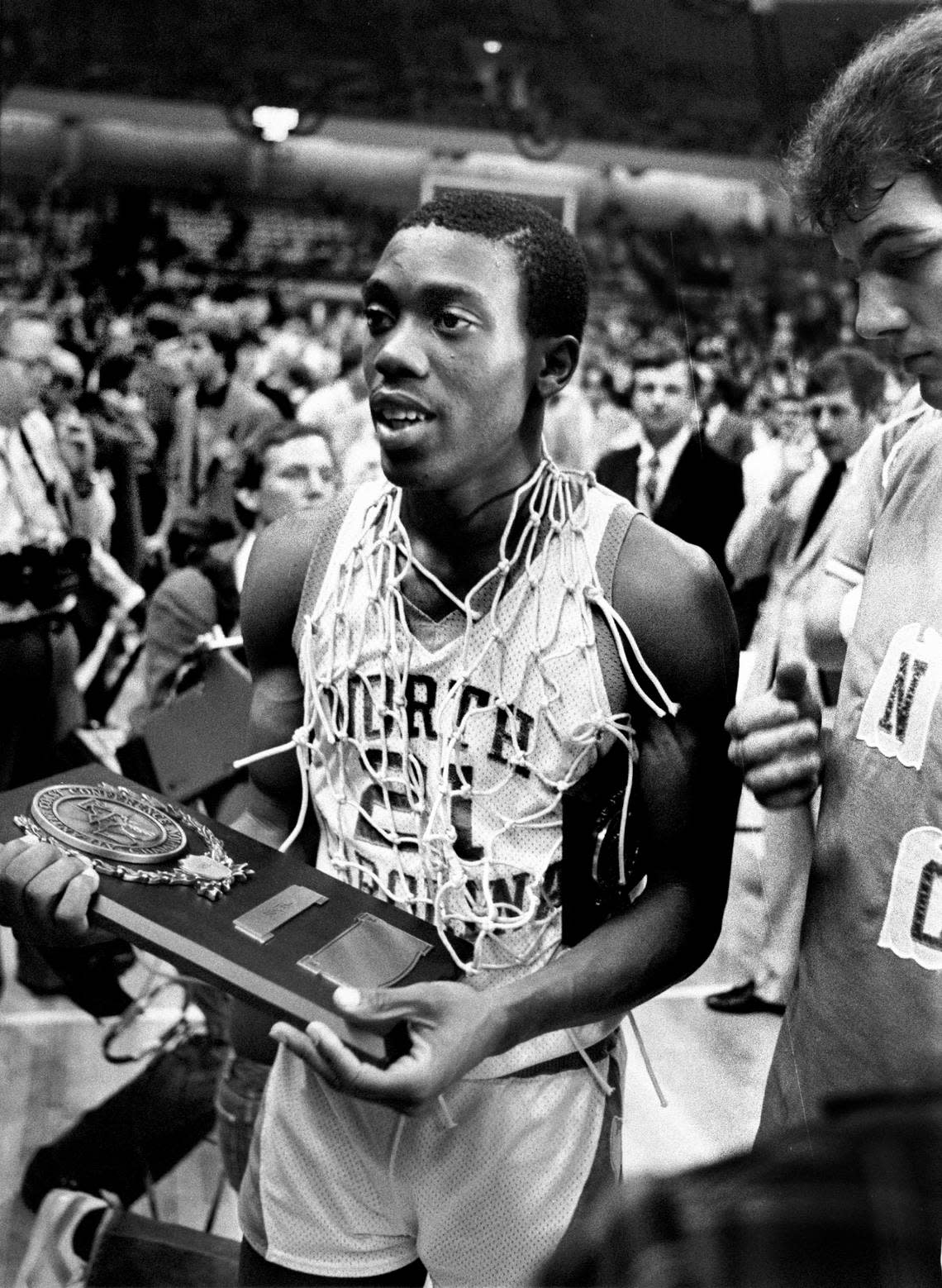 UNC’s Jimmy Black wears one of the nets as he holds a trophy following the Tar Heels win over Virginia in the 1982 ACC Tournament championship game.