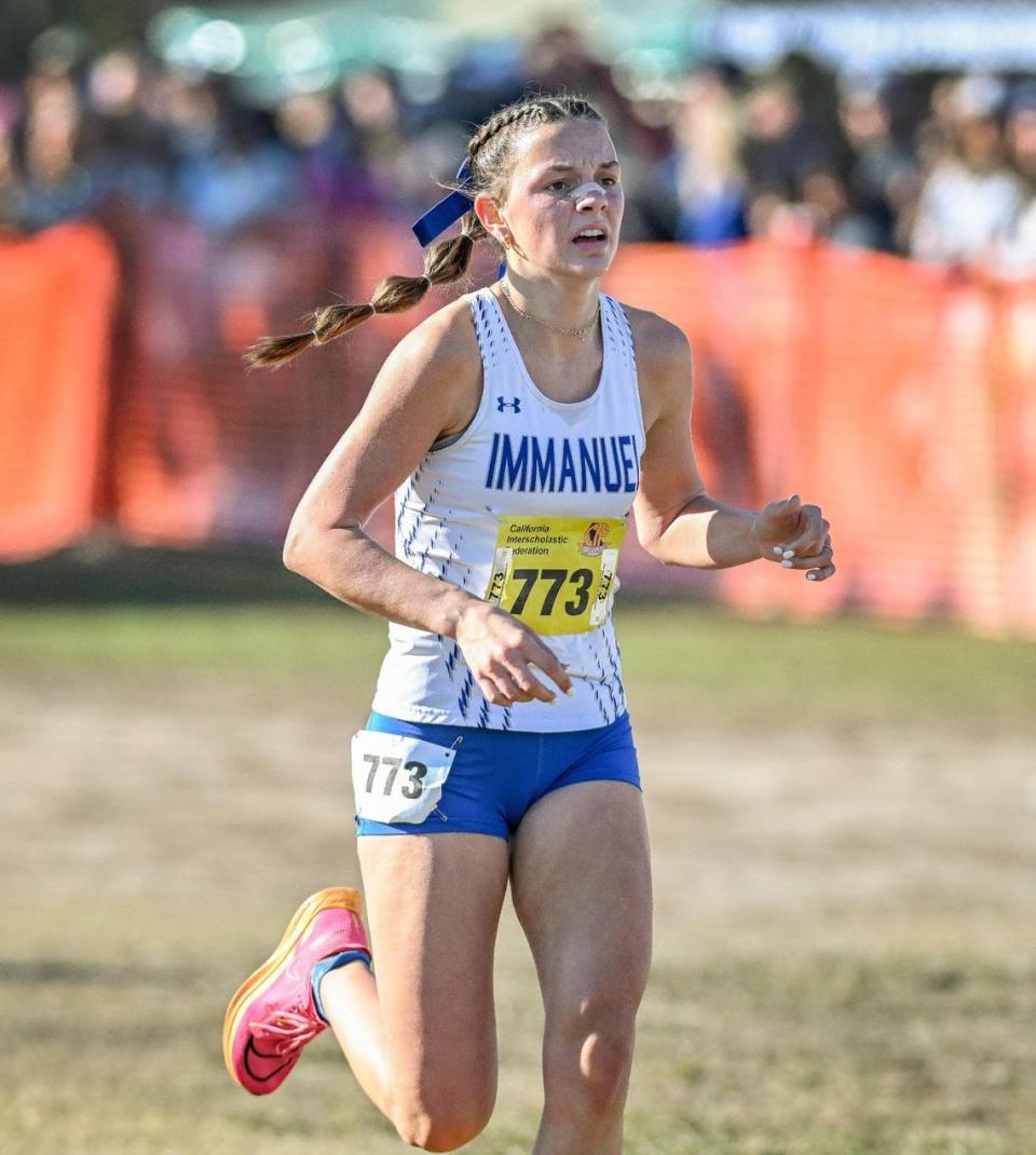 Top Immanuel runner Clara Riddle reaches the finish in the girls Division V state cross country championships at Woodward Park in Fresno on Saturday, Nov. 25, 2023.