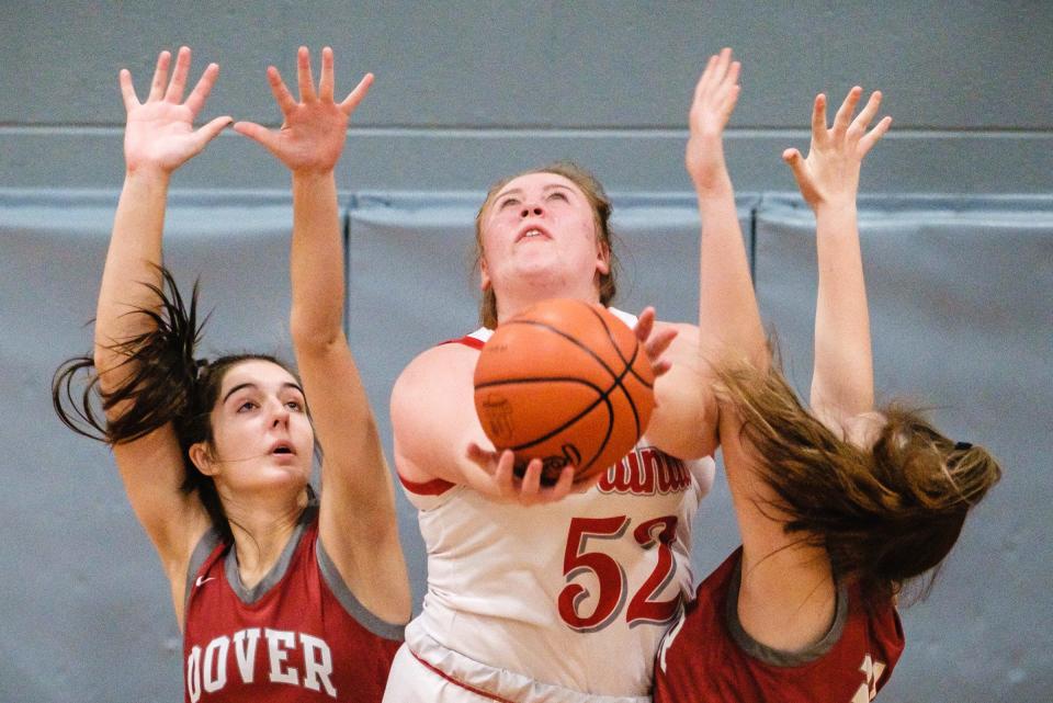 Sandy Valley's Abbey Park (52) puts up a reverse layup against Dover.