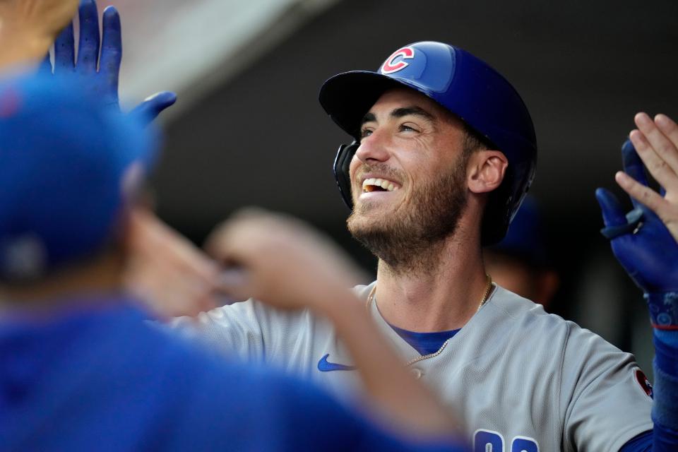 Chicago Cubs center fielder Cody Bellinger celebrates in the dugout after hitting a solo home run during a 2023 game against the Cincinnati Reds at Great American Ball Park.