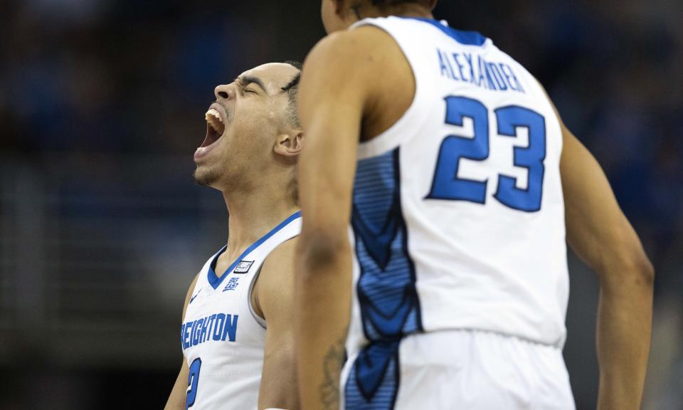 Creighton's Ryan Nembhard, left, celebrates after hitting a three pointer with teammate Trey Alexander during the first half of an NCAA college basketball game against Marquette on Tuesday, Feb. 21, 2023, in Omaha, Neb. (AP Photo/Rebecca S. Gratz)