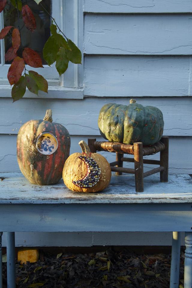 Carved Pumpkins, Smiling, on a Table Out of Doors Facing and Side