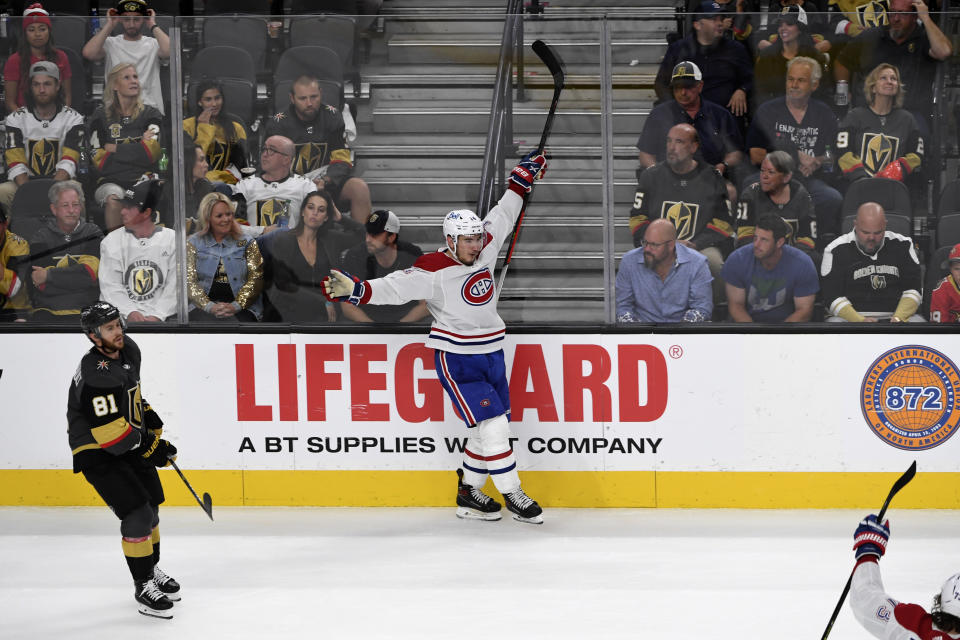 Montreal Canadiens center Nick Suzuki (14) celebrates his empty net goal as Vegas Golden Knights center Jonathan Marchessault (81) skates by during the third period in Game 5 of an NHL hockey Stanley Cup semifinal playoff series Tuesday, June 22, 2021, in Las Vegas. (AP Photo/David Becker)