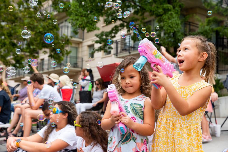 Sivalu, left, and Winna Fonua blow bubbles from their bubble guns during the annual Days of ’47 Parade in Salt Lake City on Monday, July 24, 2023. | Megan Nielsen, Deseret News