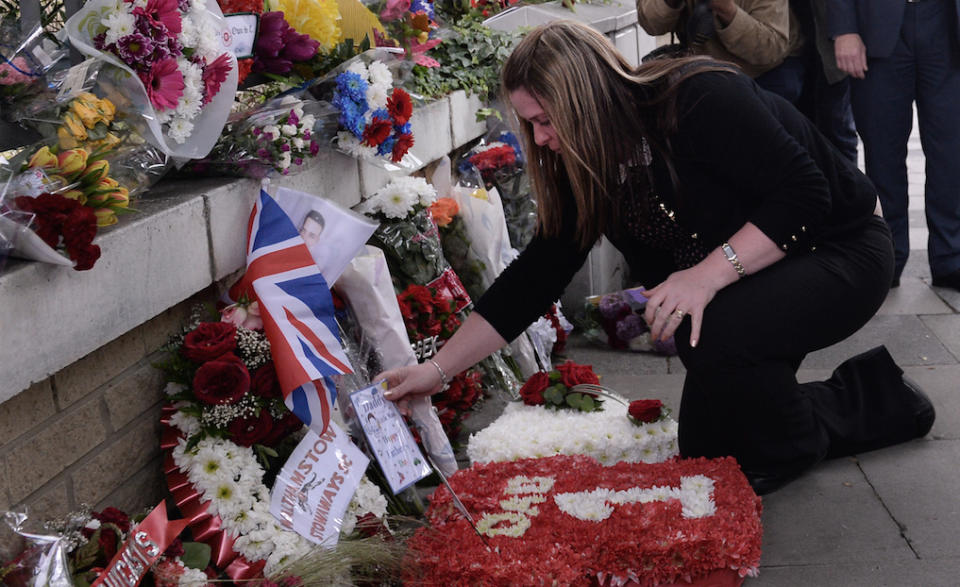 The widow of soldier Lee Rigby, Rebecca Rigby, lays tributes at the scene of his murder (Picture: PA)