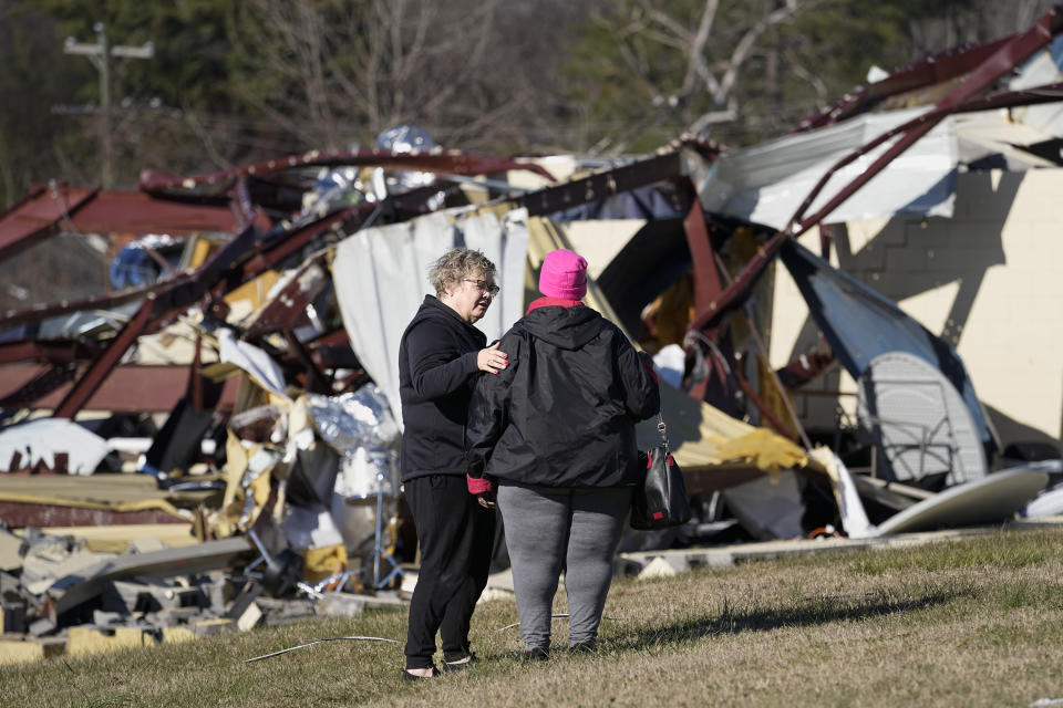 Sara Hollis, left, comforts, Shirley Presley, left, a member of Community Baptist Church, outside the church's Life Center building, Monday, Dec. 11, 2023 in Nashville, Tenn. Presley was in the building when severe storms hit the building over the weekend. (AP Photo/George Walker IV)