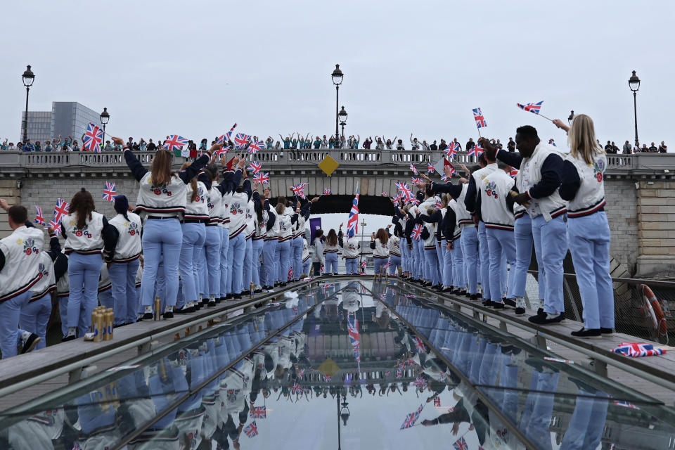 Reflections of Team Great Britain athletes are seen in the team boat as they pass under a bridge on the River Seine during the opening ceremony of the Paris 2024 Olympic Games. / Credit: Naomi Baker/Getty Images