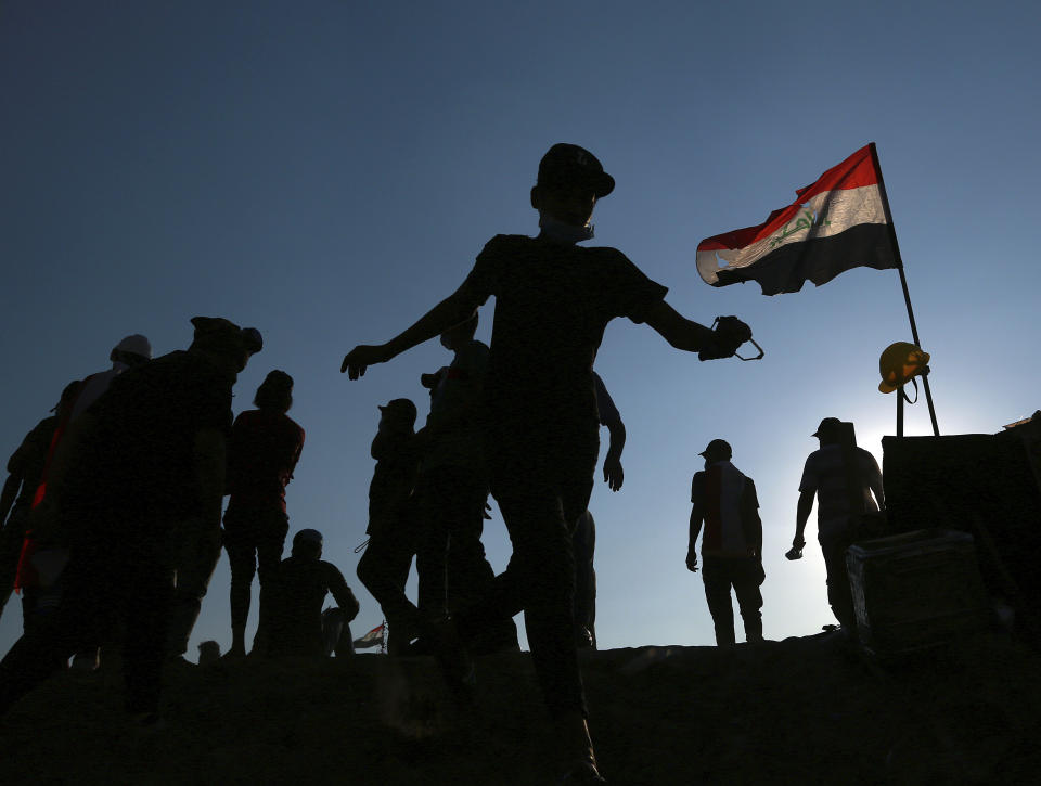 Anti-government protesters gather near the Tigris River during ongoing protests in Baghdad, Iraq, Friday, Nov. 1, 2019. (AP Photo/Hadi Mizban)