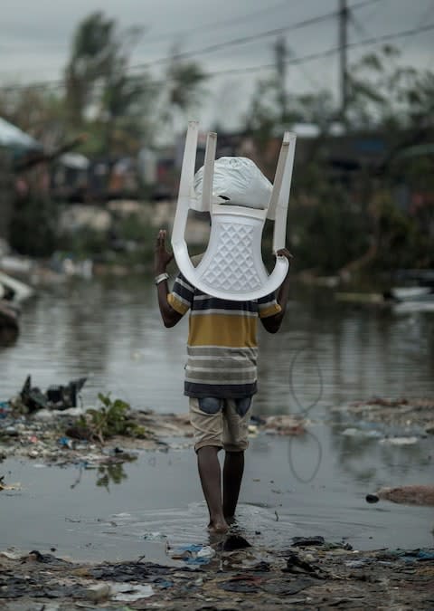 A child returning to his devastated village - Credit: Josh Estey/CARE