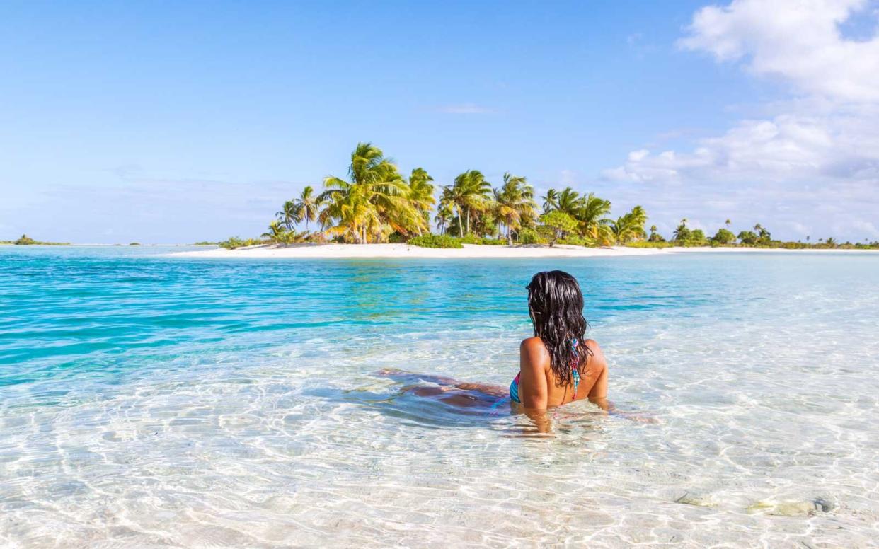 Woman sitting on an island beach