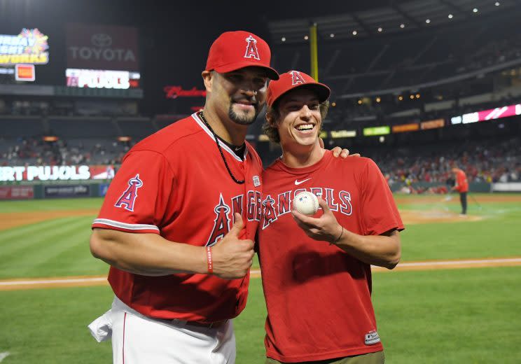 Los Angeles Angels' Albert Pujols, right, poses with Scotty Steffel after Steffel gave caught and gave him his 600th home run ball following a baseball game against the Minnesota Twins, Saturday, June 3, 2017, in Anaheim, Calif. Pujols hit his 600th career home run in the fourth inning. (AP Photo/Mark J. Terrill)