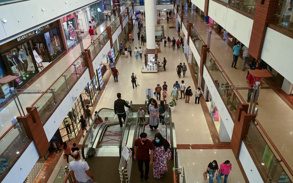 People visit Select City Mall after authorities eased a lockdown imposed as a preventive measure against coronavirus in New Delhi - PRAKASH SINGH/AFP