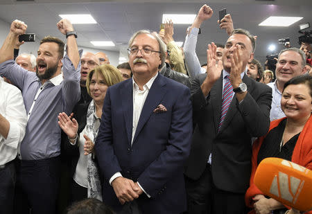 Grigol Vashadze, presidential candidate from the opposition United National Movement, surrounded by supporters reacts after the announcement of the first exit poll results in the presidential election in Tbilisi, Georgia October 28, 2018. REUTERS/Irakli Gedenidze