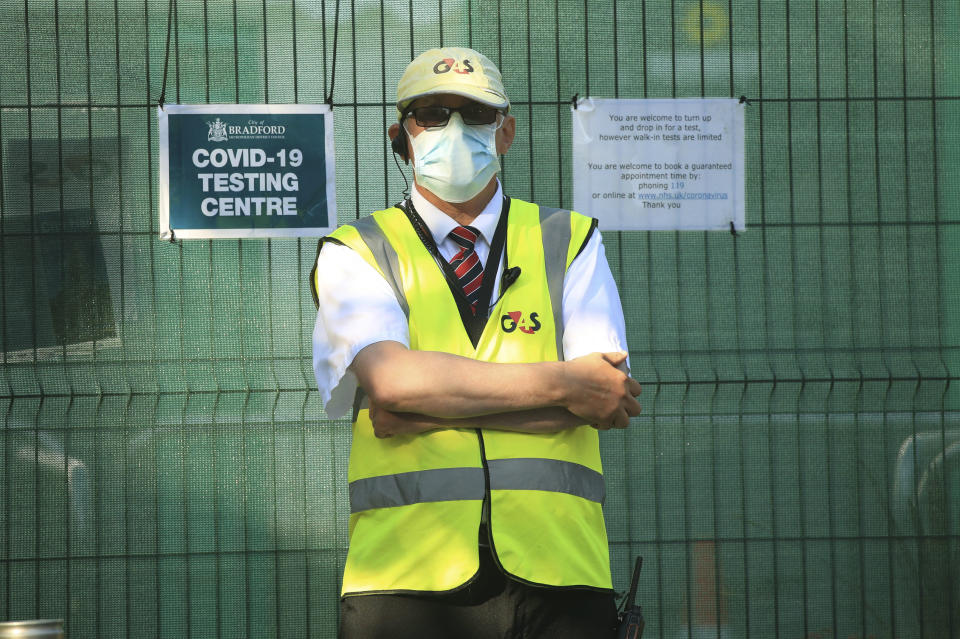 A security guard outside a Covid-19 testing centre, in Bradford, West Yorkshire, England, Friday July 31, 2020. Britain’s health secretary has defended a decision to reimpose restrictions on social life in a swath of northern England, saying it was important to keep ahead of the spread of COVID-19. Under the new restrictions, people from different households in Greater Manchester, England’s second largest metropolitan area, have been asked to not meet indoors. The same orders applies to the surrounding areas of Lancashire and West Yorkshire counties. (Danny Lawson/PA via AP)