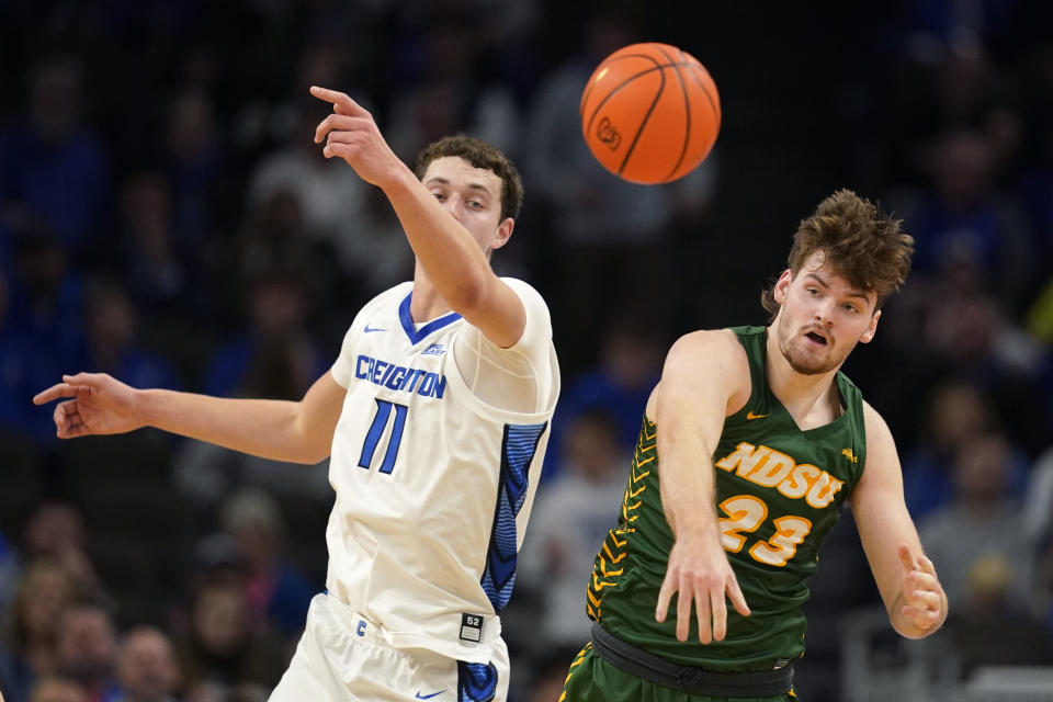 Creighton center Ryan Kalkbrenner (11) fights for a rebound with North Dakota State forward Andrew Morgan (23) during the first half of an NCAA college basketball game, Saturday, Nov. 11, 2023, in Omaha, Neb. (AP Photo/Charlie Neibergall)