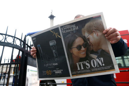 A person is seen reading the London Evening Standard with the news that Prince Harry has announced his engagement to Meghan Markle, London, Britain, November 27, 2017. REUTERS/Darrin Zammit Lupi