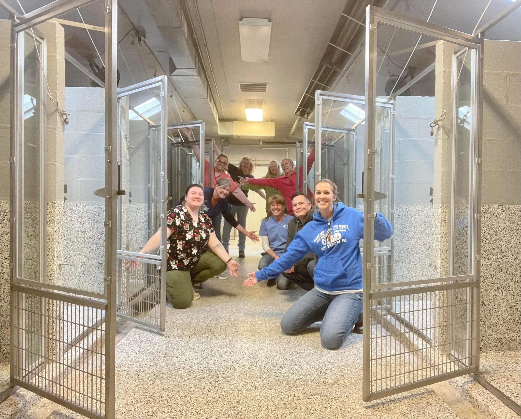 The staff of the Adams County SPCA celebrate the first time in 47 years that the kennels are empty at the SPCA.