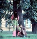 <p>Sonny and Cher posing outside in paisley and striped boho suits. </p>