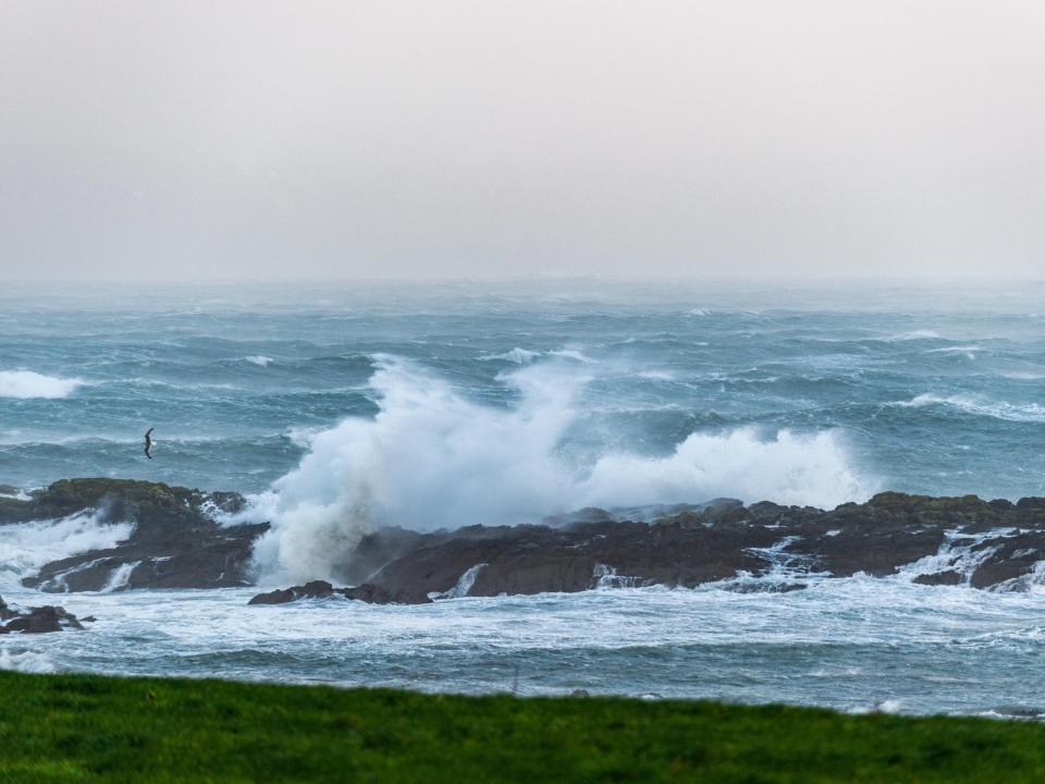 Waves crashing onto the rocks in Bantry Bay, West Cork, earlier today (PA)