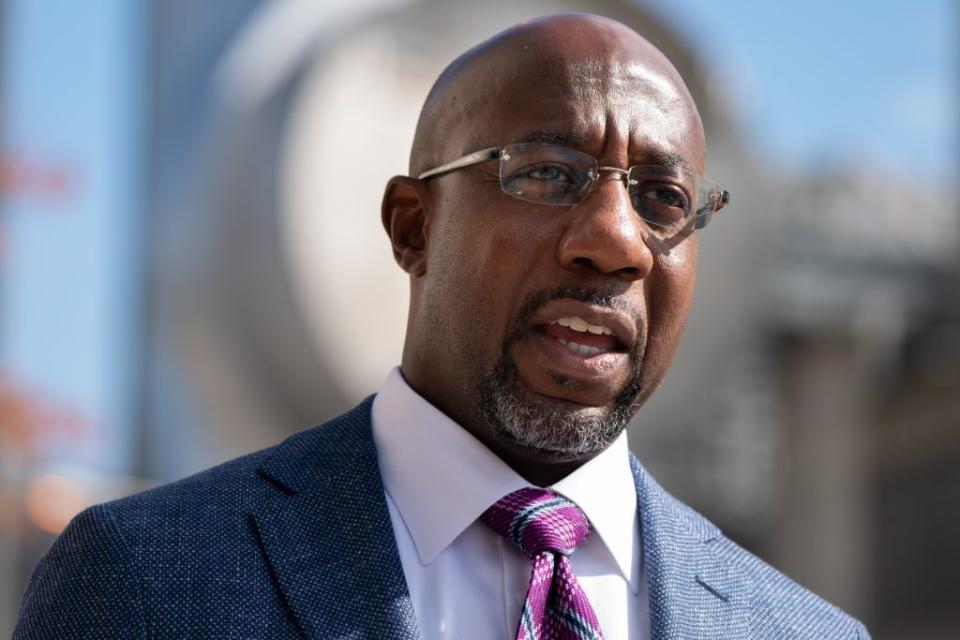 Democratic U.S. senatorial candidate Raphael Warnock speaks to the media after casting his ballot at State Farm Arena on October 21, 2020 in Atlanta, Georgia. (Photo by Elijah Nouvelage/Getty Images)