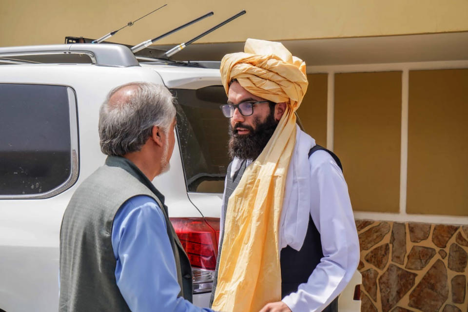 In this handout photograph released by the Taliban, senior Haqqani group leader Anas Haqqani, right, speaks to Abdullah Abdullah, head of Afghanistan's National Reconciliation Council and former government negotiator with the Taliban, in Kabul, Afghanistan, Wednesday, Aug. 18, 2021. The meeting comes after the Taliban's lightning offensive saw the militants seize the capital, Kabul. (Taliban via AP)