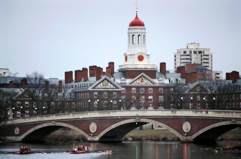 In this March 7, 2017, file photo, rowers paddle along the Charles River past the Harvard University campus in Cambridge, Mass.