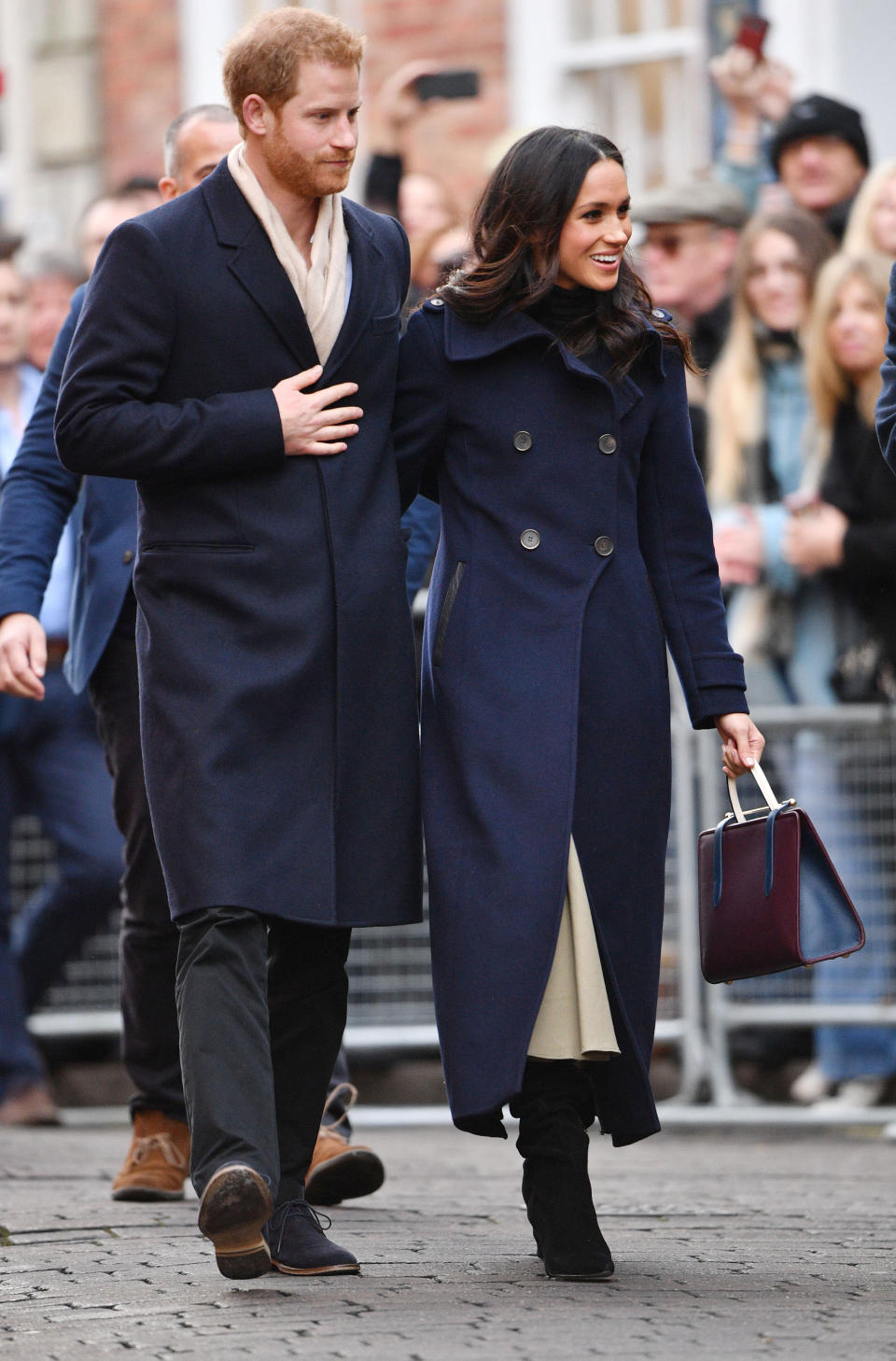 Meghan chose a navy double-breasted coat for her first meeting with the British public [Photo: Rex]