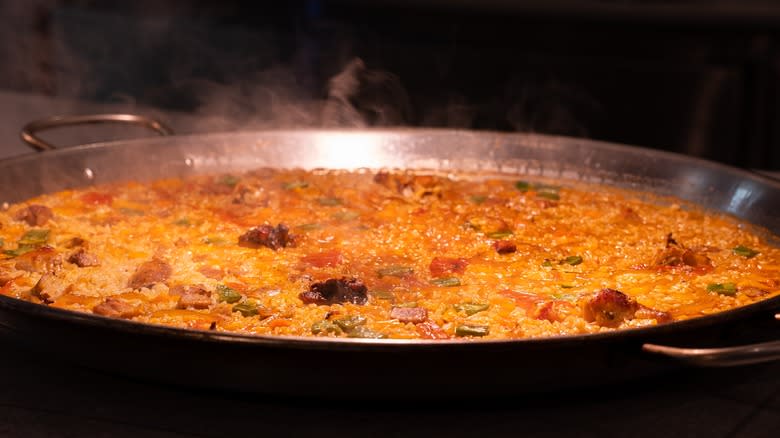 Paella rice cooking in pan