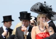 Racegoers wait for the arrival of Britain's Queen Elizabeth during the second day of the Epsom Derby Festival, in Surrey, southern England, on June 4, 2011. The Queen's horse, Carlton House, ridden by Ryan Moore, is seeking to be the first Derby winner owned by a reigning monarch since Minoru won in 1909 for King Edward VII. AFP PHOTO / ADRIAN DENNIS (Photo credit should read ADRIAN DENNIS/AFP/Getty Images)