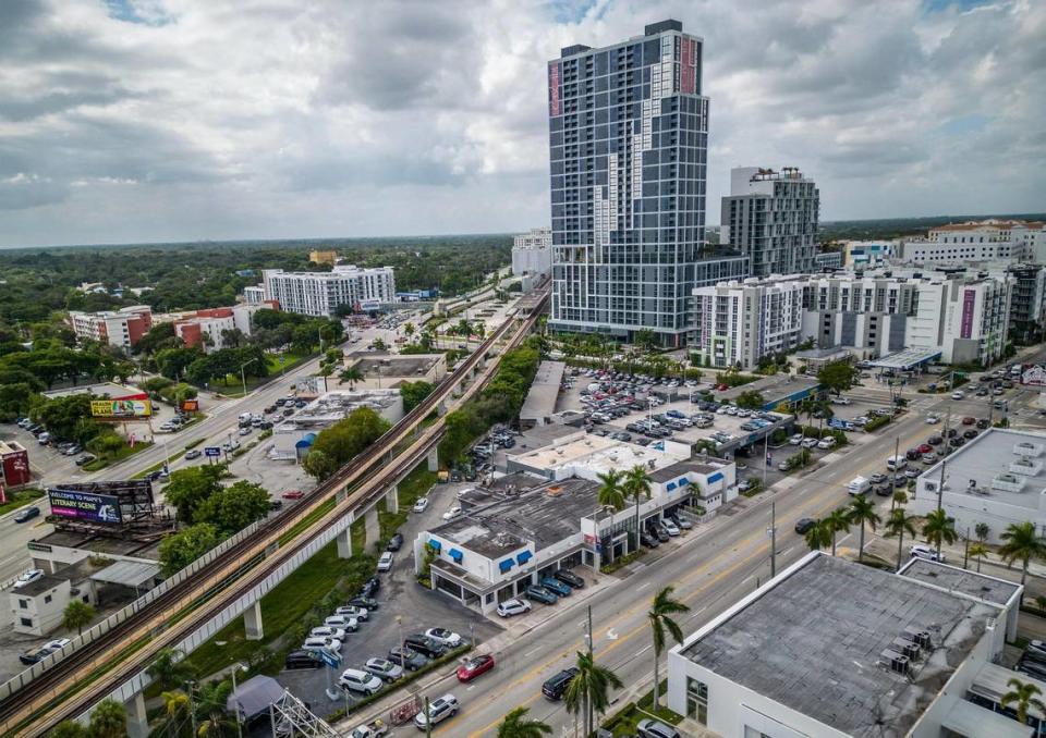 Developer Shoma Group released plans to build two 40-story apartment towers and a food hall on the Bird Road site near U.S. 1 that’s now home to a wedge-shaped portion of the Deel Volkswagen dealership, a block from the Douglas Road Metrorail station, after Miami-Dade County expanded the reach of special rapid-transit zoning rules designed to promote dense housing construction. The 37-story Cascade at Link tower, built on station property under the same rules, is visible in the background. Pedro Portal/pportal@miamiherald.com