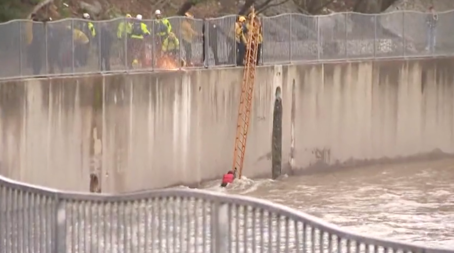 Firefighters rescue woman from storm-flooded L.A. River