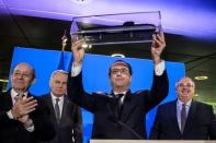 French President Francois Hollande poses holding a submarine scale model besides naval shipbuilder DCNS CEO Herve Guillou (R), Defence Minister Jean-Yves Le Drian (L) and Foreign Minister Jean-Marc Ayrault (2ndL) during a visit at the DCNS heaquarters in Paris, France, April 26, 2016 after they won the deal to build a fleet of 12 submarines for Australia. via REUTERS/Christophe Petit-Tesson/Pool