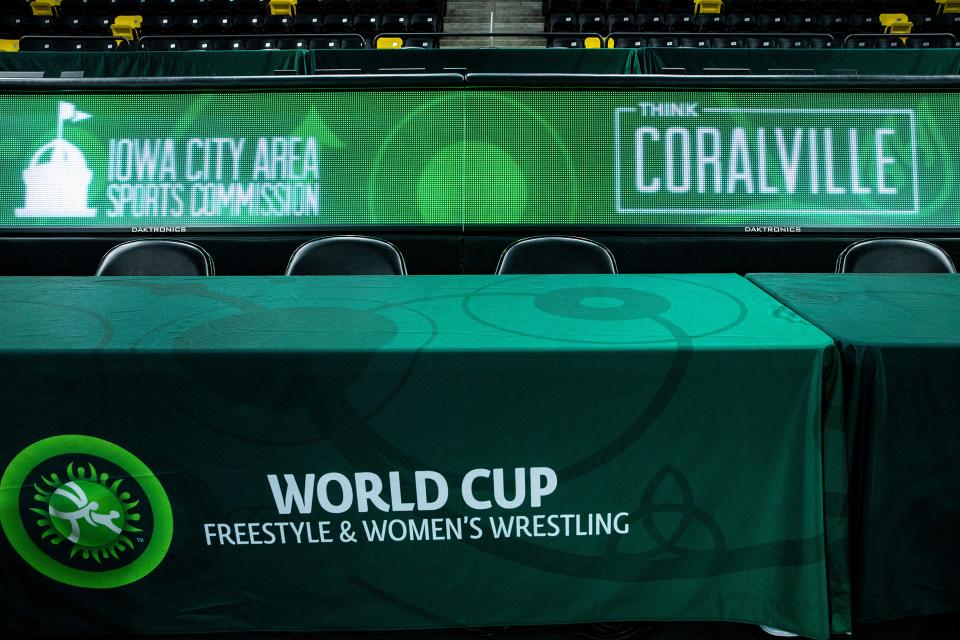 Logos for the Iowa City Area Sports Commission and Think Coralville are seen as staff work to set up for the United World Wrestling freestyle men's and women's World Cup events Wednesday at Xtream Arena in Coralville.