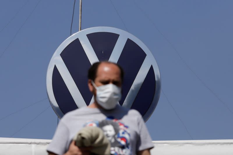 FILE PHOTO: An employee leaves the Volkswagen (VW) plant as the company will temporarily close its factories in Mexico amid growing worries over the spread of the coronavirus disease (COVID-19), in Puebla