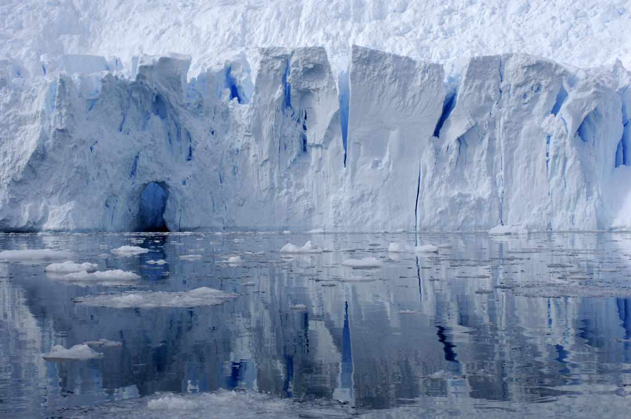 Glacier reflecting in a bay, Antarctica.