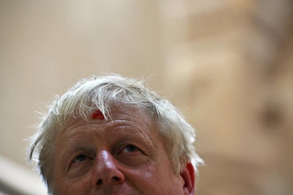 Prime Minister Boris Johnson looks on with his forehead marked by a traditional &#x002019;tilak&#x002019; as he visits the Swaminarayan Akshardham temple in Gandhinagar, Ahmedabad, as part of his two day trip to India on Thursday April 21 2022 (Ben Stansall/PA) (PA Wire)