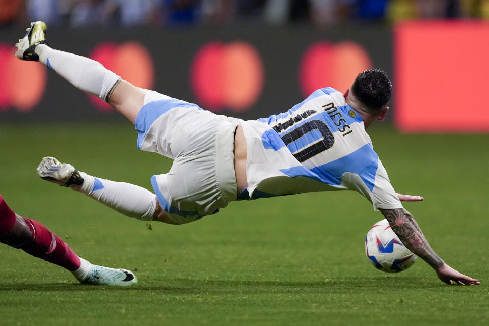 Argentina's Lionel Messi falls over during a Copa America Group A soccer match against Canada in Atlanta, Thursday, June 20, 2024. (AP Photo/Mike Stewart)