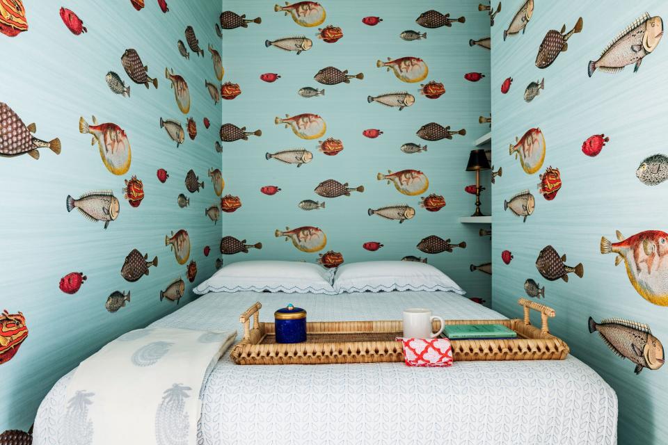 A Fornasetti for Cole & Son fish pattern wraps the study-bedroom.
