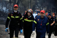<p>Rescuers arrive at the area where bodies were found following a wildfire at the village of Mati, near Athens, Greece, July 24, 2018. (Photo: Alkis Konstantinidis/Reuters) </p>