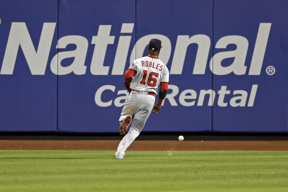 Washington Nationals center fielder Victor Robles chases down an RBI-triple by New York Mets' Brandon Nimmo during the sixth inning of a baseball game on Friday, Sept. 2, 2022, in New York. (AP Photo/Adam Hunger)