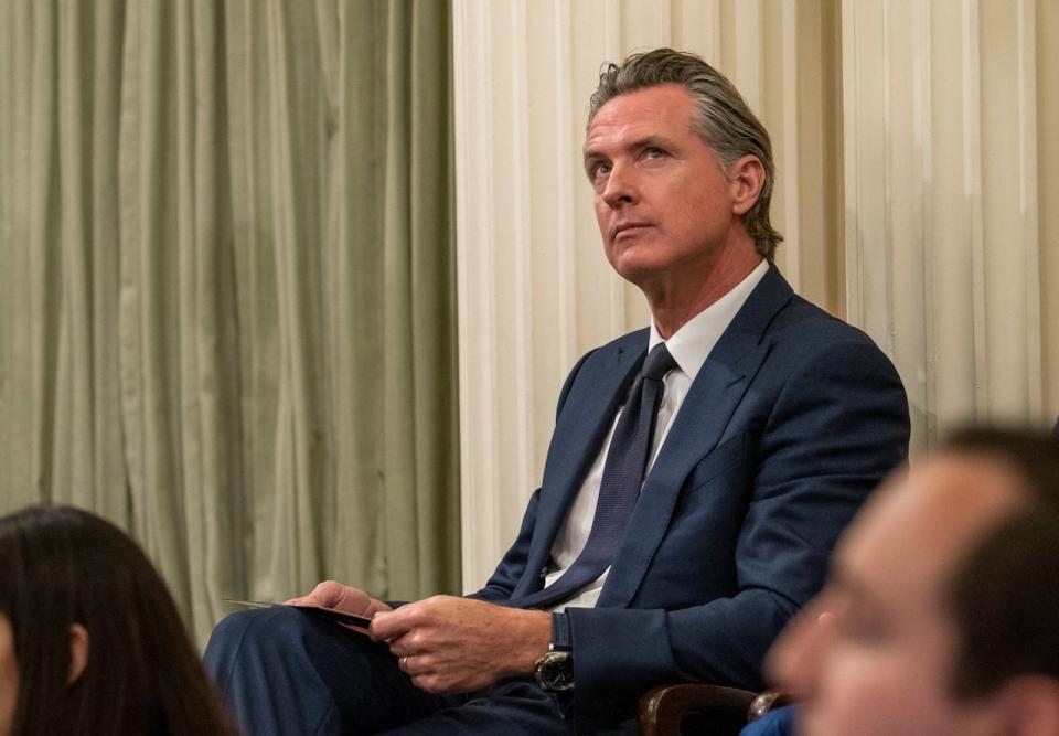 California Gov. Gavin Newsom looks up at the gallery at the swearing-in ceremony for California Assembly Speaker Robert Rivas, D-Hollister, at the Capitol in Sacramento, Calif., Friday, June 30, 2023. (AP Photo/Rich Pedroncelli)