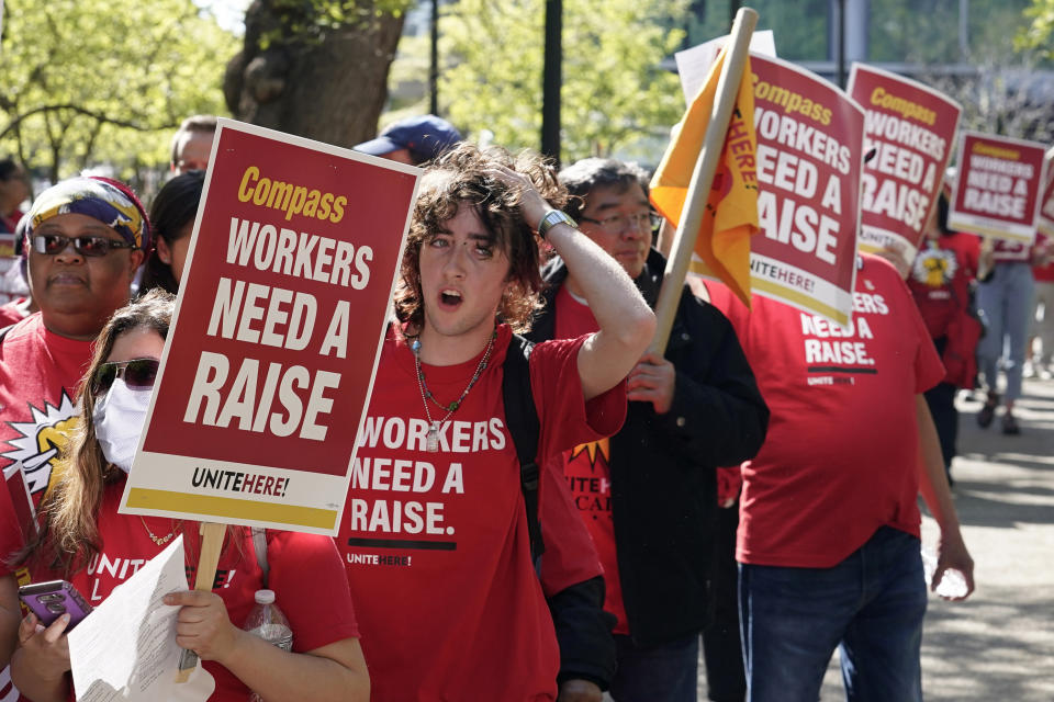 Workers who are contracted to feed World Bank employees through a firm called the Compass Group, protest for higher wages and affordable healthcare benefits, Wednesday, April 12, 2023, outside of the World Bank in Washington. (AP Photo/Mariam Zuhaib)