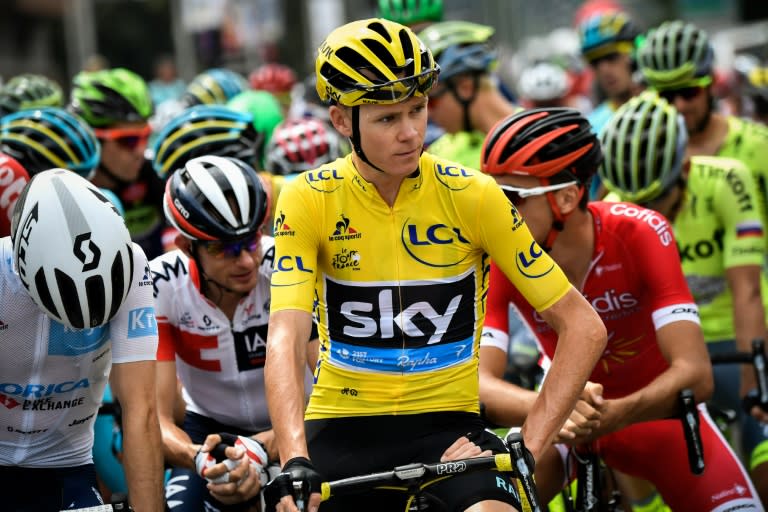 Britain's Christopher Froome (C), wearing the overall leader's yellow jersey, waits for the start of the 19th stage of the Tour de France on July 22, 2016