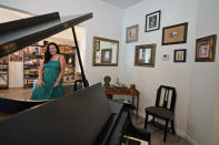 Heather Bise, owner of The House of Bise Bespoke, poses in the library, Monday, July 19, 2021, in Cleveland. Small businesses in the U.S. that depend on tourism and vacationers say business is bouncing back, as people re-book postponed trips and take advantage of loosening restrictions, a positive sign for the businesses that have struggled for more than a year. Bise started in 2019 and catered to international tourists, attracting guests from New Zealand, Botswana, Eastern Europe and elsewhere. (AP Photo/Tony Dejak)