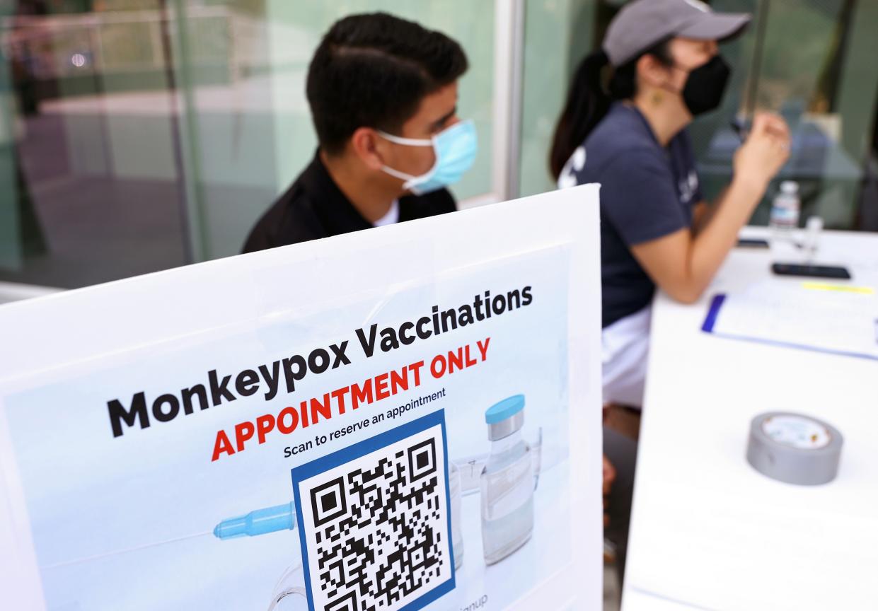 Health workers sit at a check-in table at a pop-up monkeypox vaccination clinic which opened today by the Los Angeles County Department of Public Health at the West Hollywood Library on August 3, 2022 in West Hollywood, California.