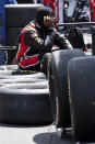 A crew member sits on tires during a NASCAR Xfinity Series auto race at Charlotte Motor Speedway, Saturday, May 29, 2021, in Charlotte, N.C. (AP Photo/Ben Gray)