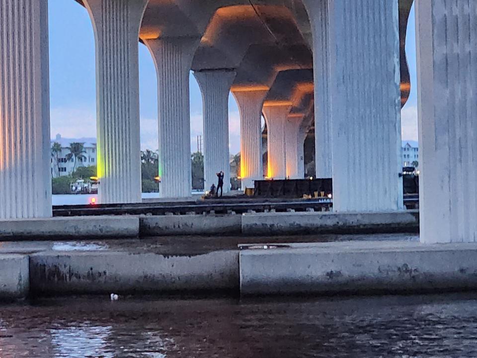 Two men inspect a barge after it struck a fender at the Stuart railroad bridge on Sept. 23, 2023.