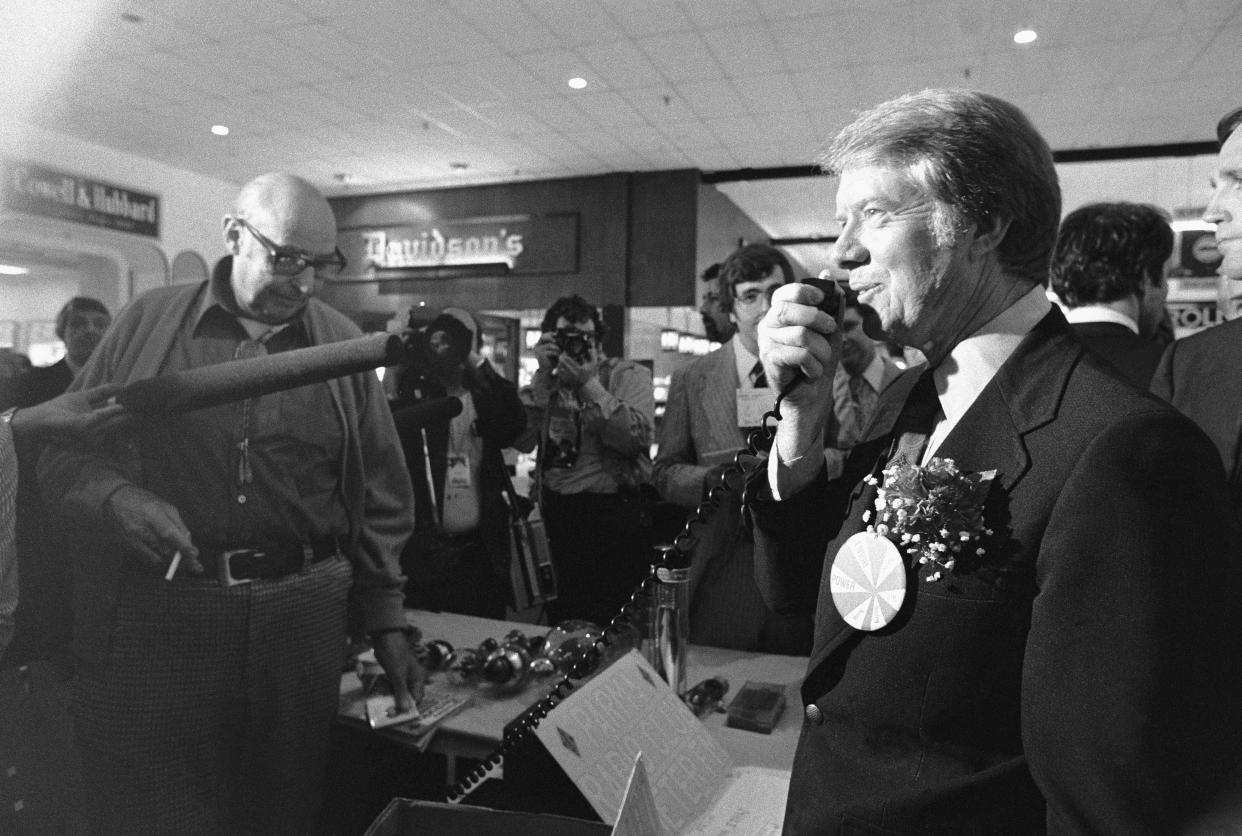 6/4/1976-Parma, OH- Jimmy Carter takes his campaign to the CB airways as he talks on a CB radio after he stopped at a Senior Citizen arts and craft display as he toured a shopping mall.