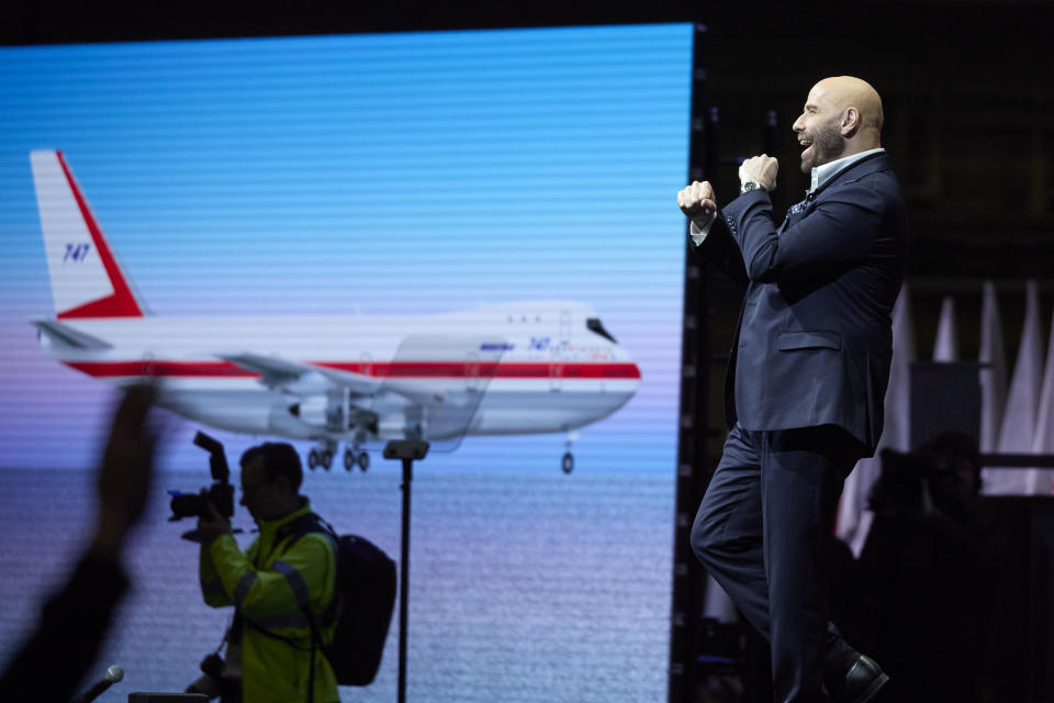 Actor and pilot John Travolta speaks during a ceremony for the delivery of the final Boeing 747 jumbo jet, Tuesday, Jan. 31, 2023, in Everett, Wash. Since it debuted in 1969, the 747 has served as a cargo plane, a commercial aircraft capable of carrying nearly 500 passengers, and the Air Force One presidential aircraft. (AP Photo/John Froschauer)